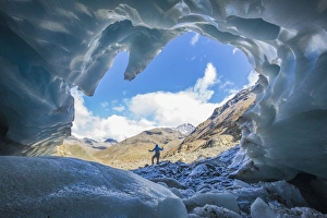 Hiker inside Forni Glacier, Forni Valley, Stelvio National Park, Valtellina, Lombardy