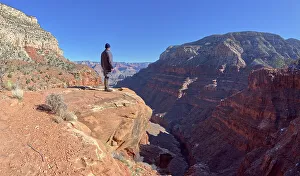 A hiker looking out from a cliff in Hermit Canyon at Grand Canyon, Grand Canyon National Park, UNESCO World Heritage Site, Arizona, United States of America, North America