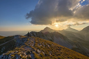 Looking At View Prints: Hiker in front of mountain Portella at sunset, Gran Sasso e Monti della Laga National Park