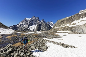 Hiker on a mountain trail, Barre des Ecrins, Ecrins National Park, French Dauphine Alps