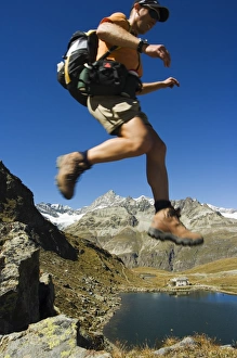 One Young Man Only Prints: Hiker running on trail above lake at Schwarzee Paradise