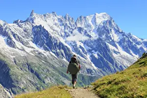 Footpath Prints: Hiker runs along trail with views on Grandes Jorasses and the Giant Tooth, Veny Valley