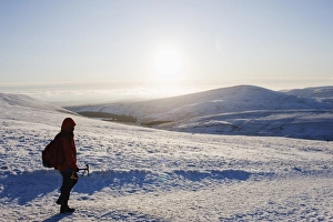 Hiker Prints: Hiker on snow covered Pen y Fan mountain, Brecon Beacons National Park