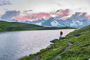Mid Adults Prints: Hiker stands near the shore of Fenetre lake admiring the sunset over the massif of Mount Blanc