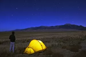 Images Dated 14th October 2010: Hiker and tent illuminated under the night sky, Great Sand Dunes National Park