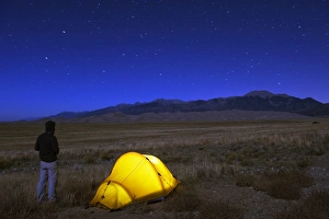 Night Sky Prints: Hiker and tent illuminated under the night sky, Great Sand Dunes National Park