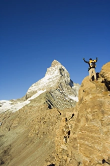 Walker Prints: Hiker on trail celebrating at the sight of the Matterhorn