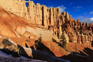 Hoodoo Prints: Hiker in front of Wall of Windows lit by early morning sun