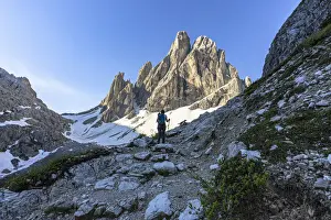 40 To 45 Prints: Hiker woman with backpack walking on path to Croda Dei Toni at sunrise, Val Fiscalina