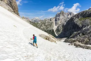 40 To 45 Prints: Hiker woman walking on snowy mountain ridge on path to Rifugio Locatelli hut