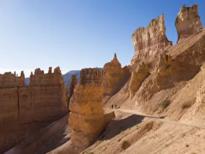 Sunset Point Prints: Two hikers heading down the Navajo Loop Trail below Sunset Point