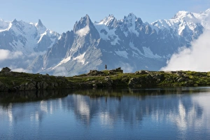 The Great Outdoors Prints: Hikers reflected in Lake Cheserys, Mont Blanc, French Alps, France, Europe