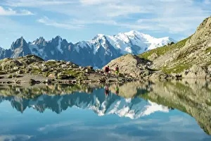 Trekking Prints: Hikers and the summit of Mont Blanc reflected in Lac Blanc on the Tour du Mont Blanc