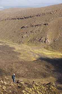 Taupo Prints: Hikers walking through a lava field on the Tongariro Crossing