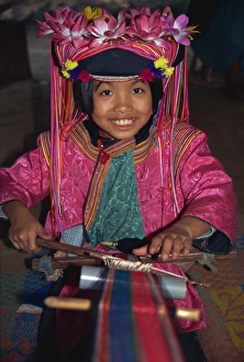 Hill tribe girl weaving on a narrow loom in Chiang Mai