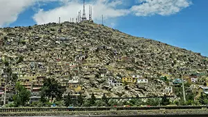 Settlement Prints: Hills with buildings and telecommunications towers in Kabul, Afghanistan during daytime