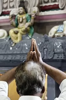 Images Dated 5th July 2009: Hindu devotee praying in a Tamil temple, London, England, United Kingdom, Europe