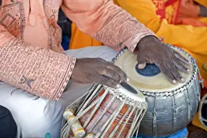 Text Prints: Hindu musician playing the tabla (drums) with typical black spot made from a mixture of gum