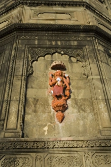 Hindu temple god on wall on banks of the Narmada River