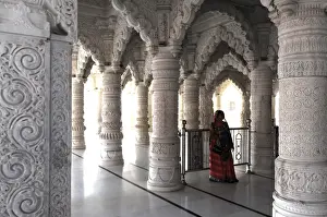 Sari Prints: Hindu woman in red sari inside the ornate white marble Swaminarayan Temple, built