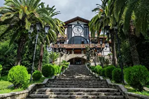 Clock Prints: Historic architecture stands tall at Gagra hotel surrounded by lush greenery in Abkhazia during day time hours