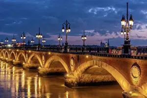 Golden Hour Prints: Historic bridge, Pont de Pierre over the Garonne River at blue hour (dusk)