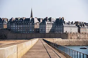 Time Prints: Historic fortified walls and spire of Saint-Malo viewed from a stone pier in Brittany