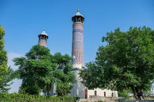 Pilgrimage Prints: Historic mosque with tall towers surrounded by trees in Aghdam, Qarabaqh, Azerbaijan