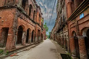 Significance Prints: Historic streets of Panam City show remnants of brick buildings from past eras in Bangladesh with an empty pathway