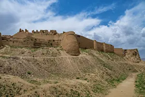 Hilltop Prints: Historic structure stands on a hill with clouds above in Ghazni
