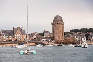 Watercraft Prints: Historic Tour Solidor tower stands by the Rance River with waterfront buildings in Saint Servan