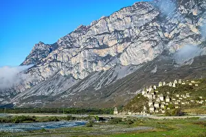 Remains Prints: Historical structures sit at the base of a large mountain in the Caucasus region of North Ossetia