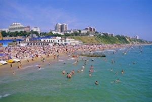 Enjoying Prints: Holidaymakers in the sea and on the beach, Bournemouth, Dorset, England, UK