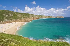 Holidaymakers and tourists sunbathing on Porthcurno beach, Cornwall, England