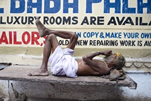 Udaipur Prints: Holy man (Saddhu) resting on a marble slab, Udaipur, Rajasthan, India, Asia