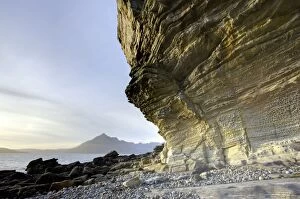 Images Dated 11th September 2009: Honeycombe Rock bathed in evening light with Cuillin Hills in distance