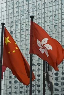 The Hong Kong and Chinese flags fly in Central, Hong Kong, China, Asia