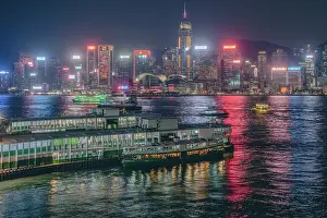 Bustling Prints: The Hong Kong Skyline at night with the Star Ferry terminal in the foreground