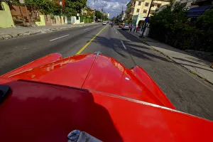Vintage Car Prints: The hood of a vintage car driving the streets of Havana, Havana, Cuba, West Indies