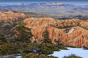 Hoodoo Prints: Hoodoos, vegetation and snow with a distant view on a winters late afternoon