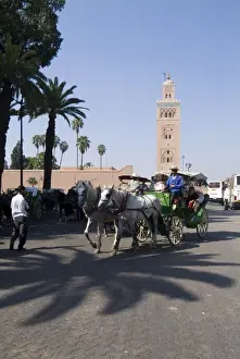 Koutoubia Prints: Horse and carriage near Jemaa el Fna with Koutoubia in background