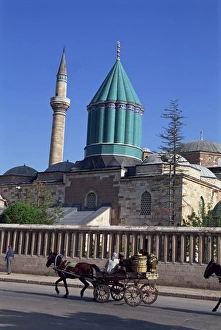 Horse and cart passes the Mevlana Tekke Museum with