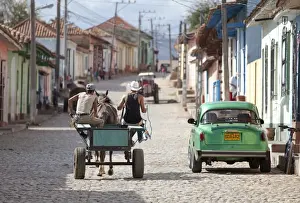 Cart Prints: Horse and cart and vintage American car on cobbled street in the historic centre of Trinidad