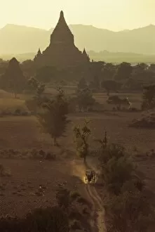 Horse-drawn buggy tearing across plain at dusk, Bagan (Pagan), Myanmar (Burma), Asia