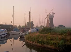 Wind Mill Collection: Horsey Wind Pump and boats moored on the Norfolk Broads at dawn, Norfolk