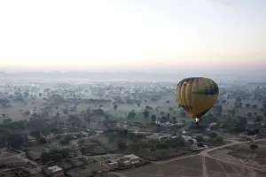 Hot Air Balloon Prints: Hot air balloon in the early morning, flying over countryside and the village of Samode