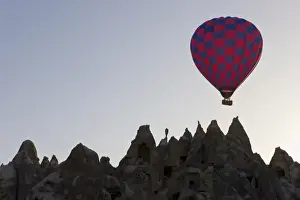 Hot Air Balloon Prints: Hot air balloon taking off with tourists on board for a flight over the famous volcanic tufa rock formations around