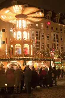 Eating And Drinking Prints: Hot wine (gluhwein) stall with Nativity Scene on roof at Christmas Market next to Frauen Church at night
