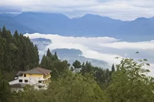 House near Rumtek Gompa Complex overlooking Gangtok with clouds drifting over city