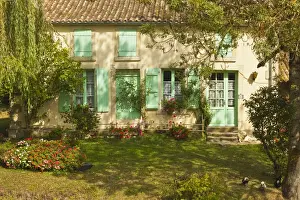 Shutters Prints: House with typical regional green shutters in the Marais Poitevin (Green Venice) wetlands
